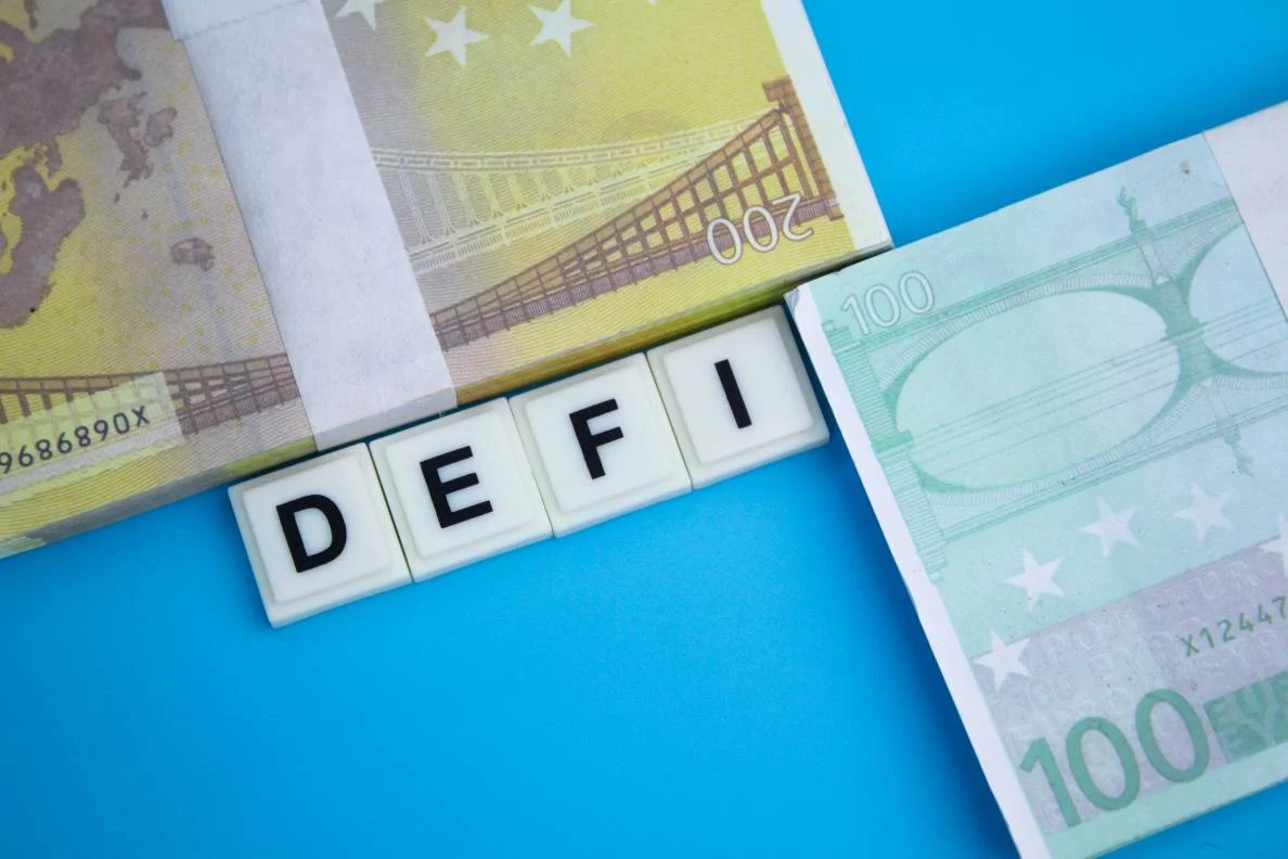  Euro and dollar money with the word DeFi. The concept of decentralized finance. 