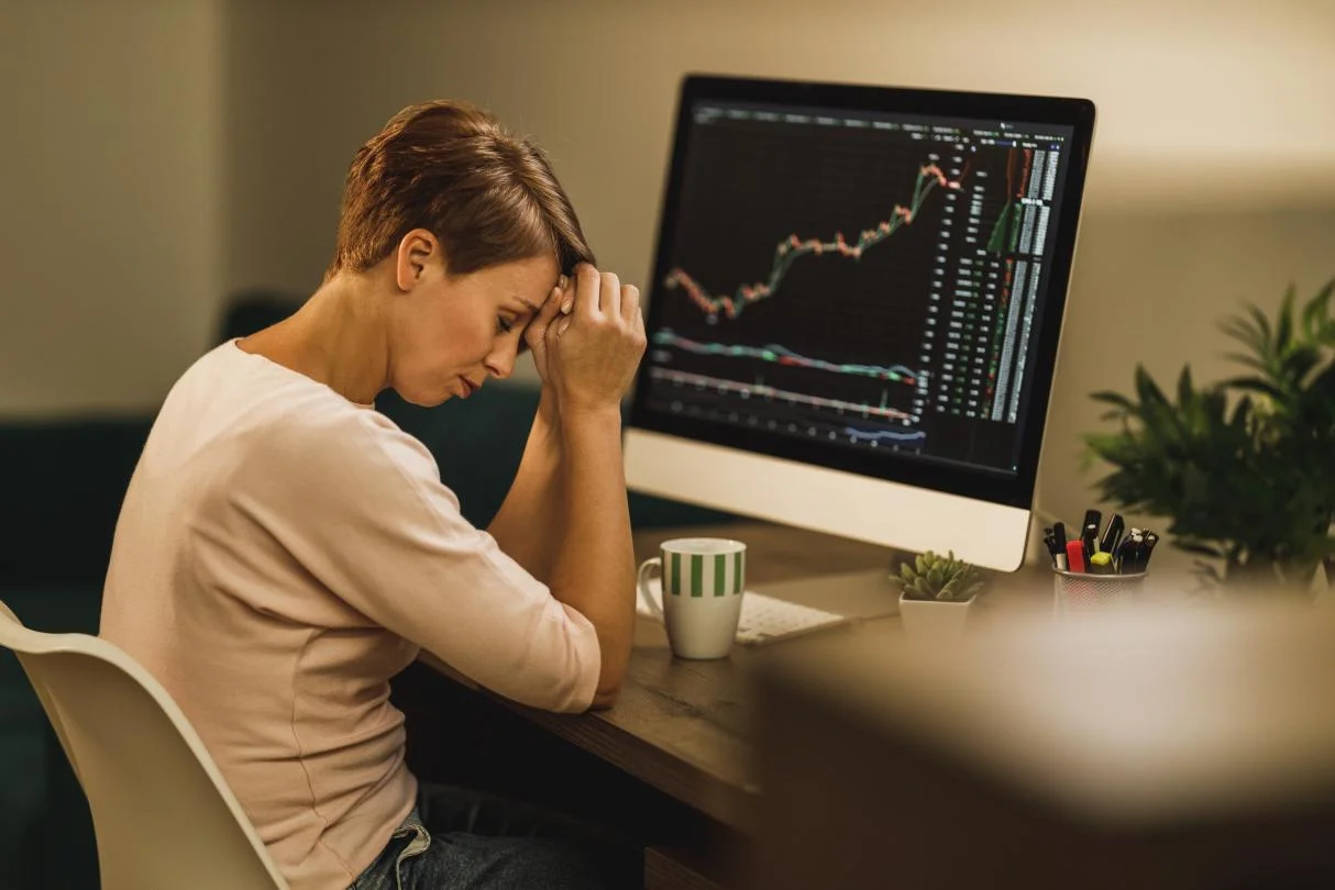  Woman experiencing stress in trading cryptocurrencies 